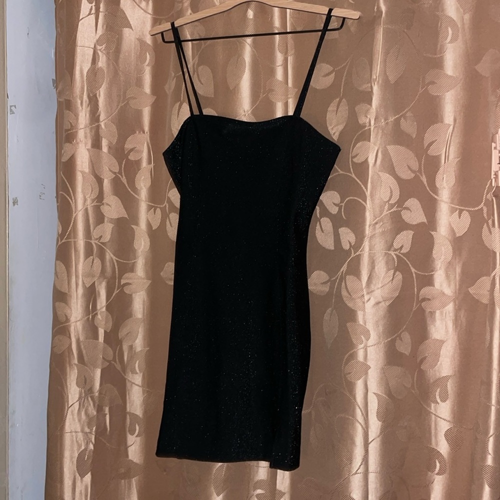Black, sparkly dress, and it’s spaghetti strap